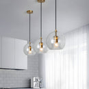 Glass globe pendant light over the island pendant lights
