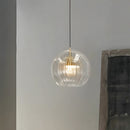 Glass globe pendant light over the island pendant lights